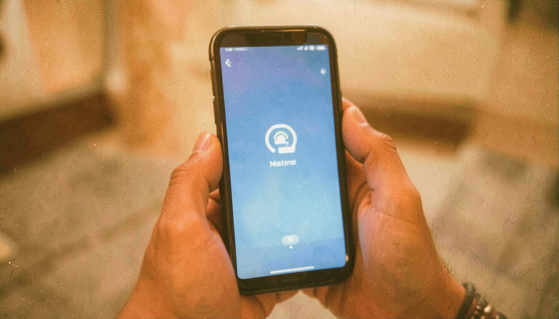 Vintage analog photograph with visible grain of a hand holding a smartphone displaying an eSIM activation screen, dominant blue and warm amber tones with soft natural light, calm and informative mood.
